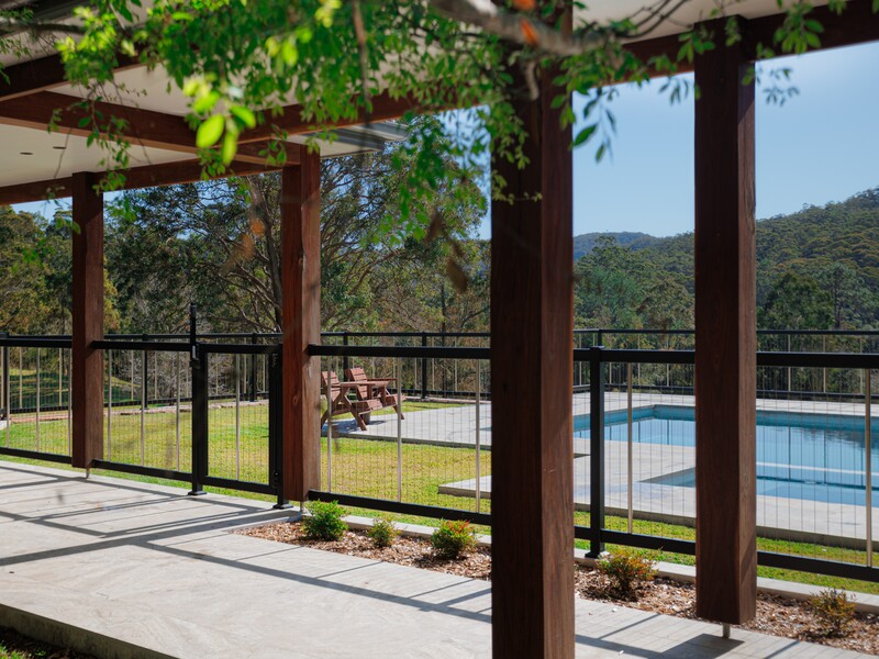 Stylish and safe aluminium pool fence with vertical cable, powder-coated for durability and beauty.
